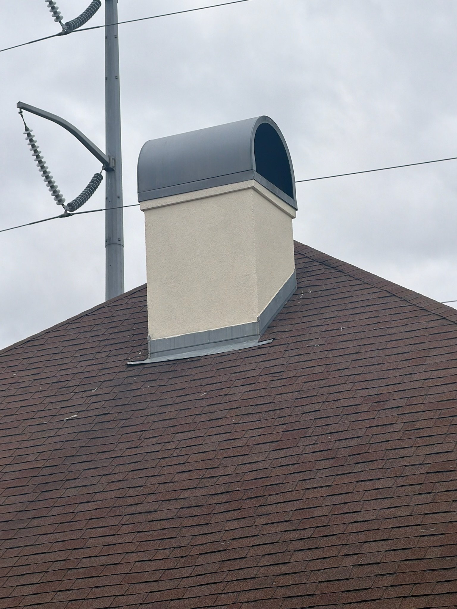 New chimney flashing and architectural shingles around brick chimney