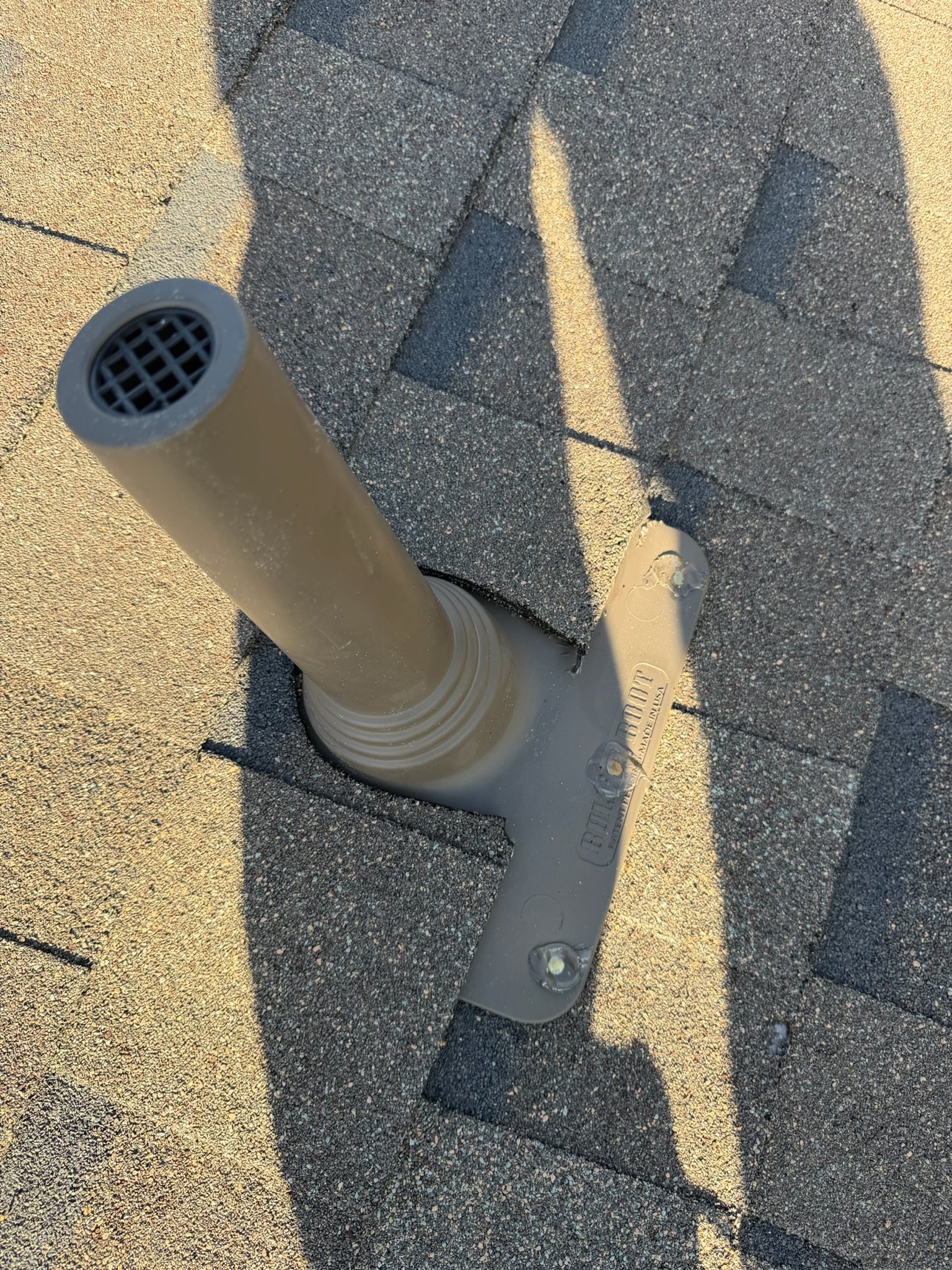 New pipe boot flashing installed around plumbing vent on asphalt shingle roof