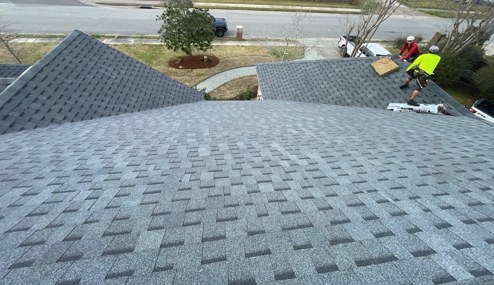 Aerial view of completed asphalt shingle roof installation on Louisiana home