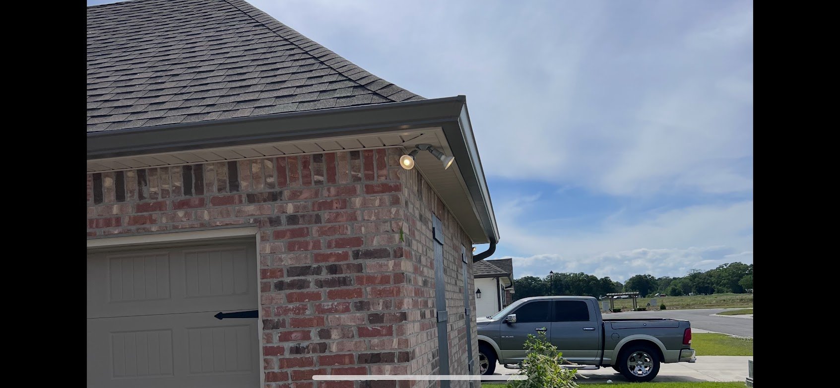 Completed asphalt shingle roof replacement on brick home in Lafayette area